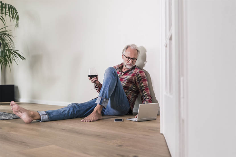 Mature Man Sitting On The Floor, Holding Book, Smiling